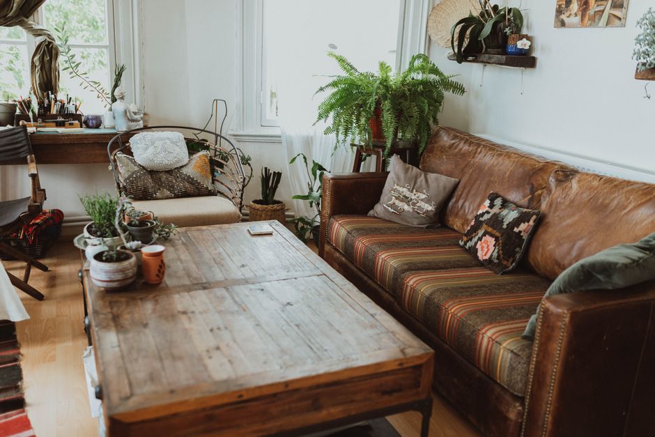 cozy apartment living room with throw pillows plants and layered textiles