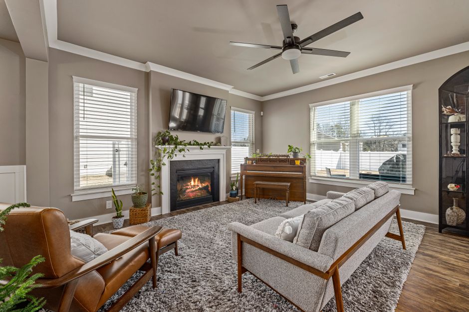 Warm and inviting living room featuring a fireplace, stylish furniture, and modern decor.