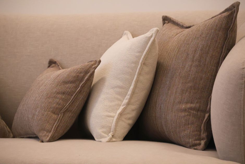 Neutral throw pillows styled on a sofa
