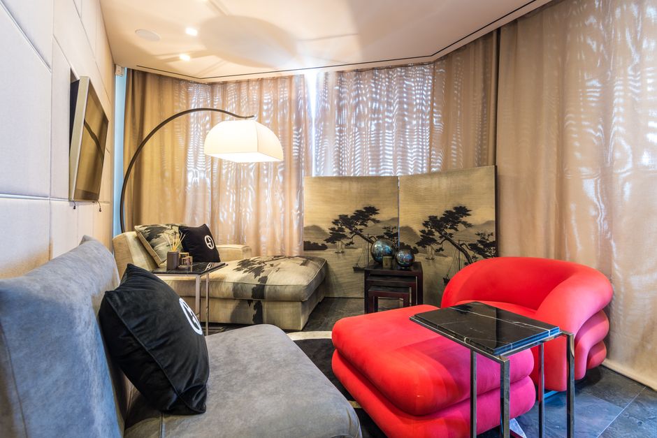 An arc floor lamp arching over a sofa