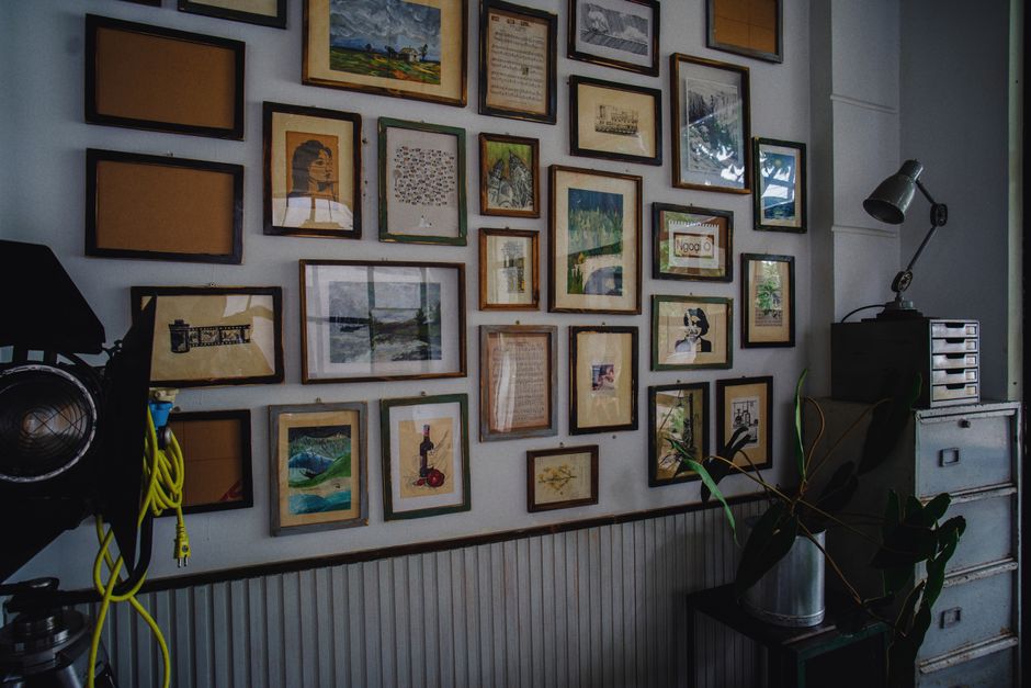 A gallery wall with mixed frames and art