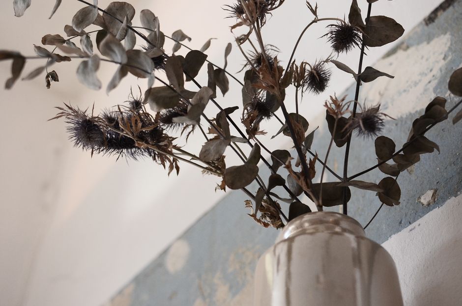 A greige wall styled with neutral decor