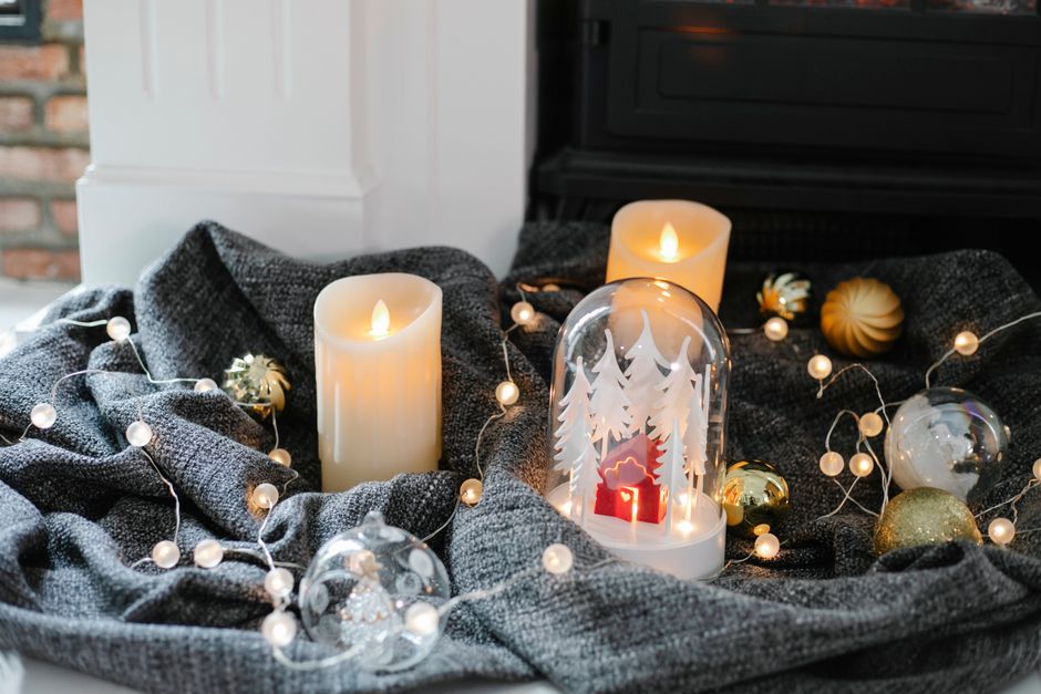 A cozy Christmas mantel glowing with warm lights and candles
