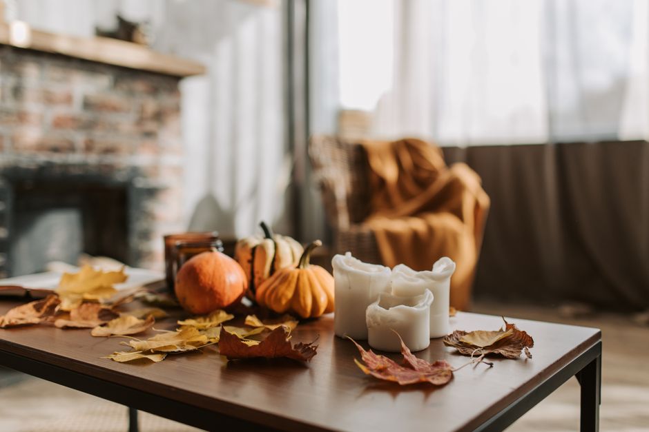 A cozy autumn living room with warm blankets and candles