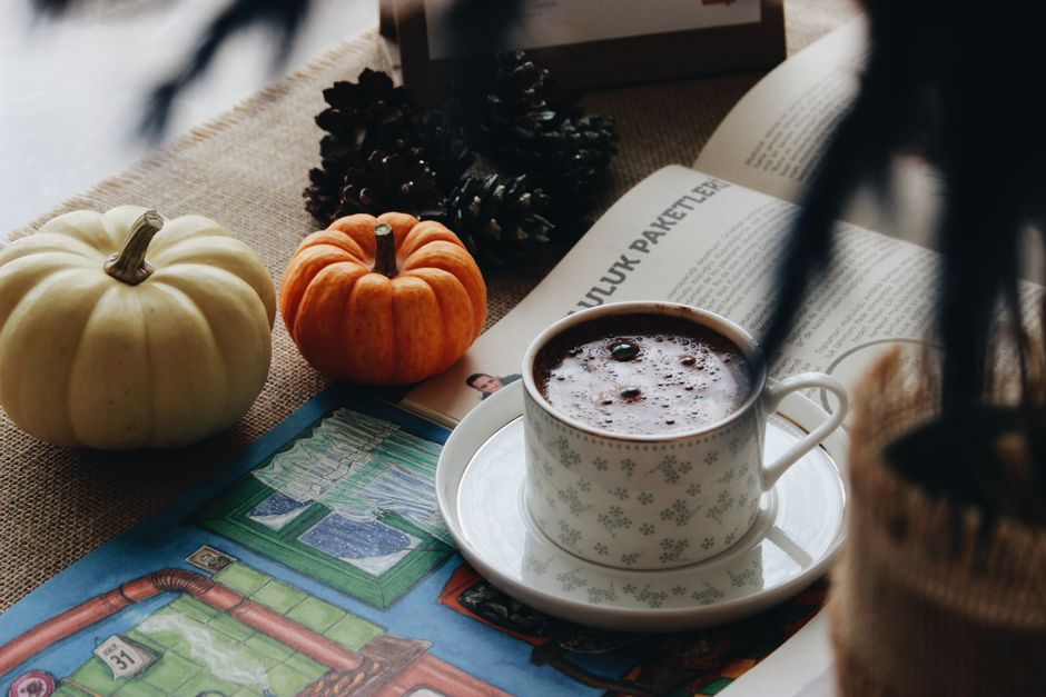 Autumn branches and neutral pumpkins styled on a coffee table