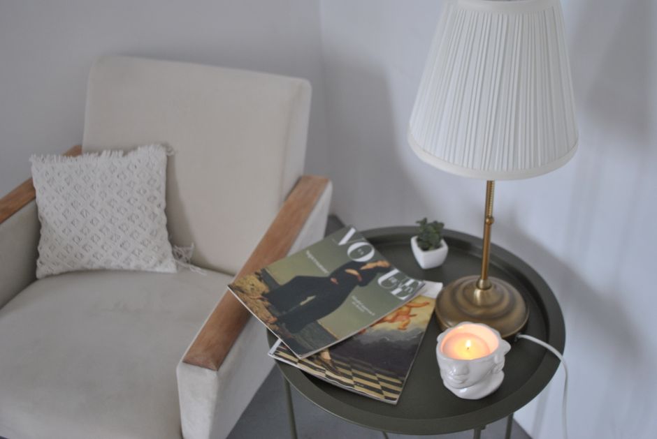 A cozy reading nook with an armchair and warm lamp