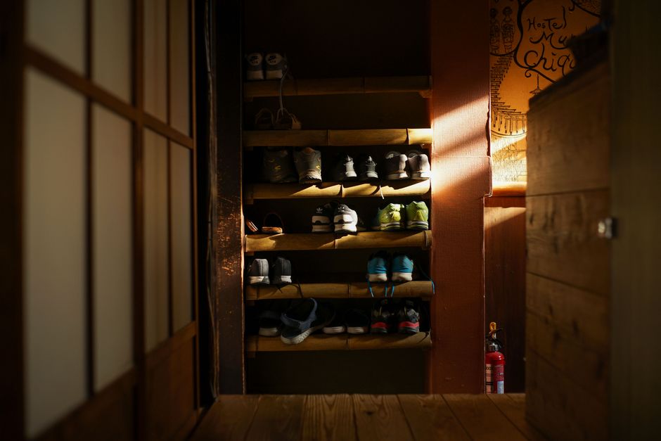 An entryway bench with baskets for shoe storage underneath