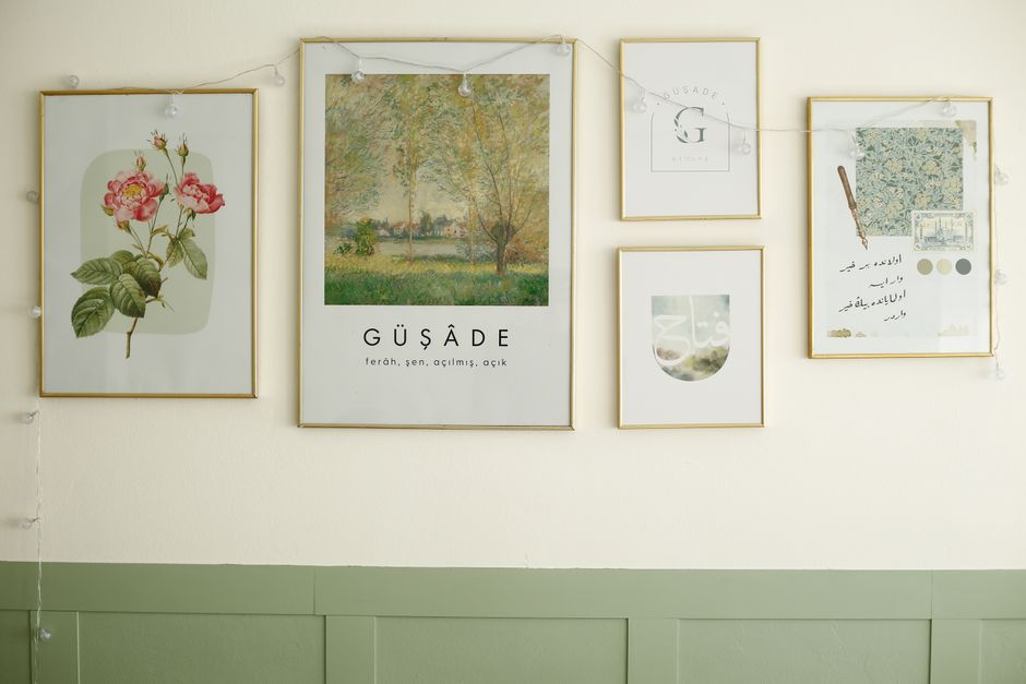 A gallery wall of framed prints above a sofa