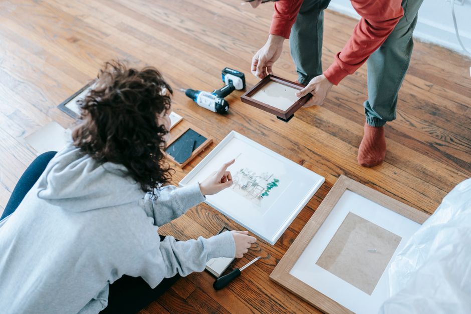 Framed art laid out on the floor for planning