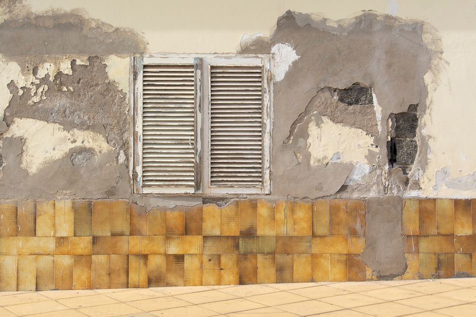 Applying a peel-and-stick tile sheet to a wall
