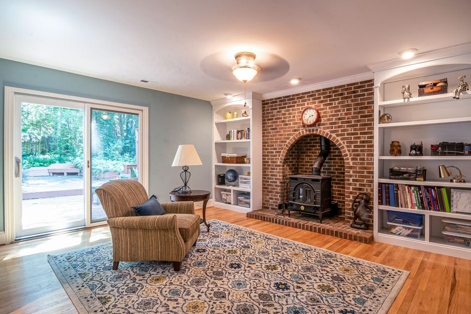 cozy reading corner with armchair bookshelf and warm floor lamp
