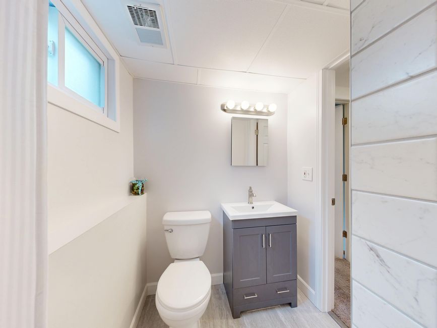 A bright, modern small bathroom in neutral tones