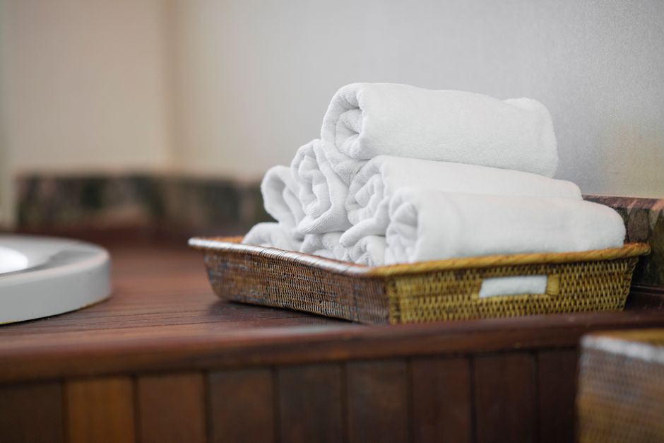 Plush white towels rolled in a basket
