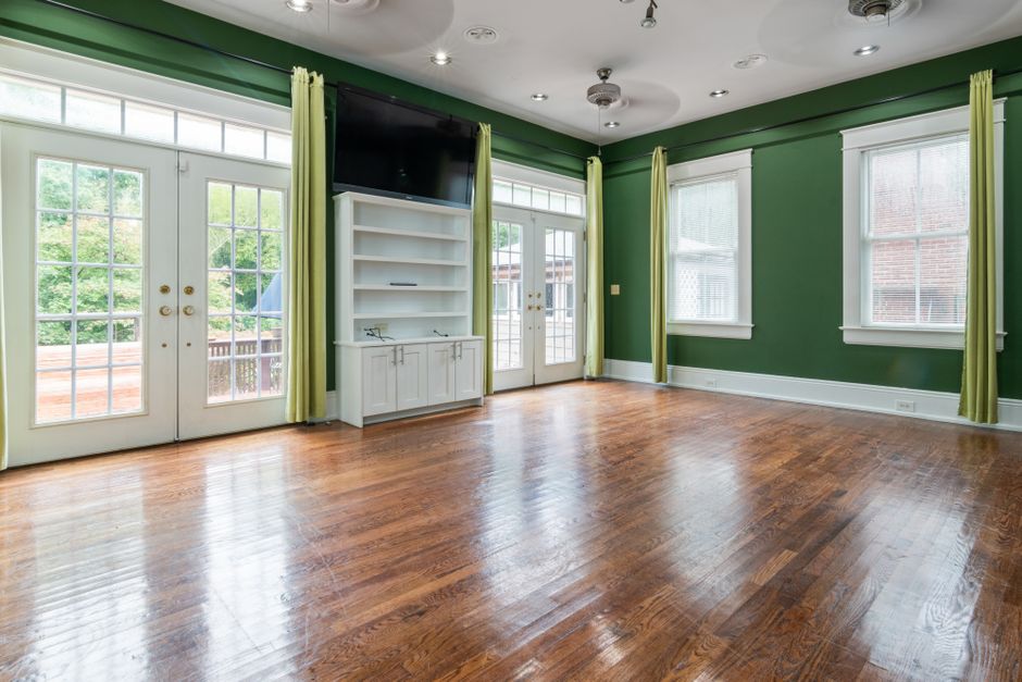 A bedroom fully color-drenched in deep green from walls to ceiling and trim