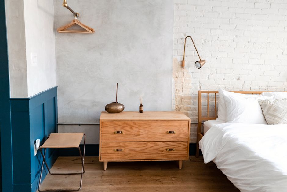 Nightstand with drawer open showing organized small storage basket
