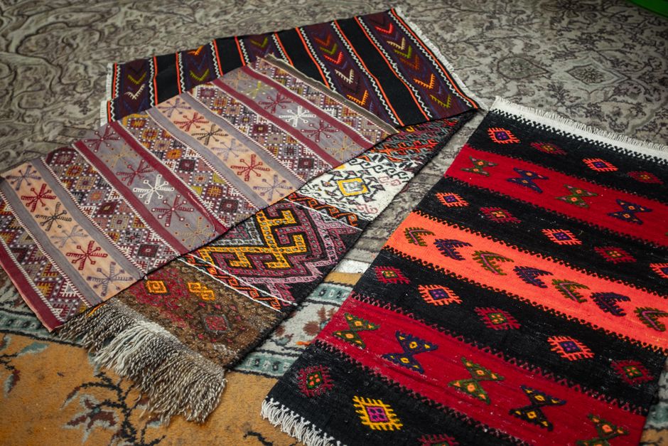 Layered jute and patterned area rugs in a living room