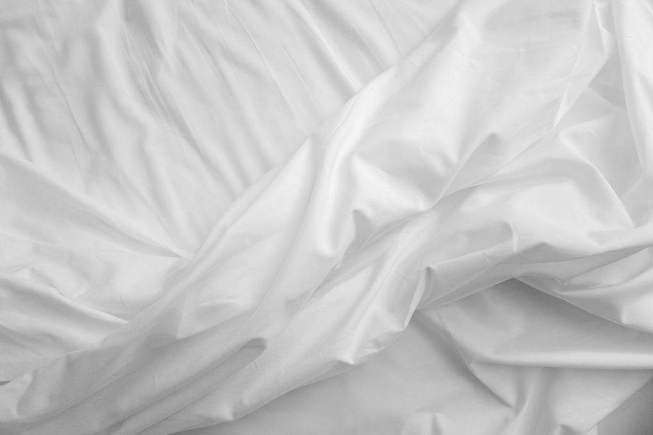Bed sheet set neatly folded and tucked inside a matching pillowcase