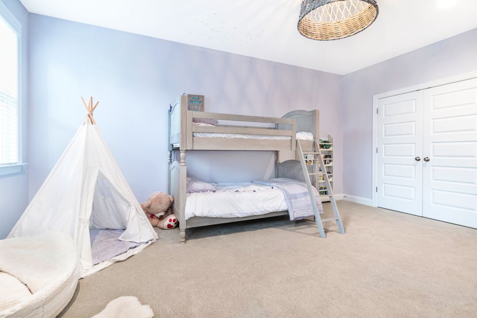 Bright, cozy kids' bedroom with playful decor and organized storage