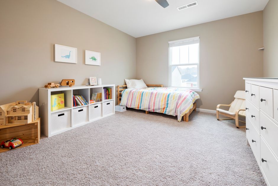 Organized low storage bins and shelving in a children's bedroom