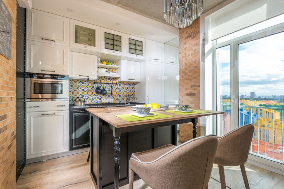 Small kitchen featuring a compact island with seating
