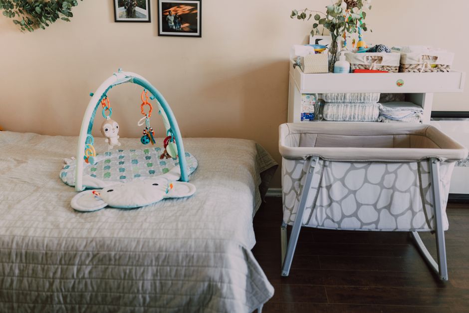 Nursery dresser used as a changing station with baskets and framed art on top