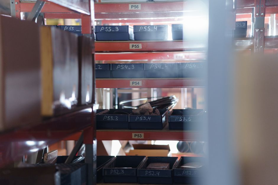 Closet shelving with labeled storage bins and folded clothes