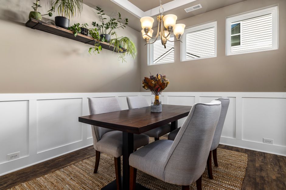 Dining nook with bench seating and a wall-mounted shelf above