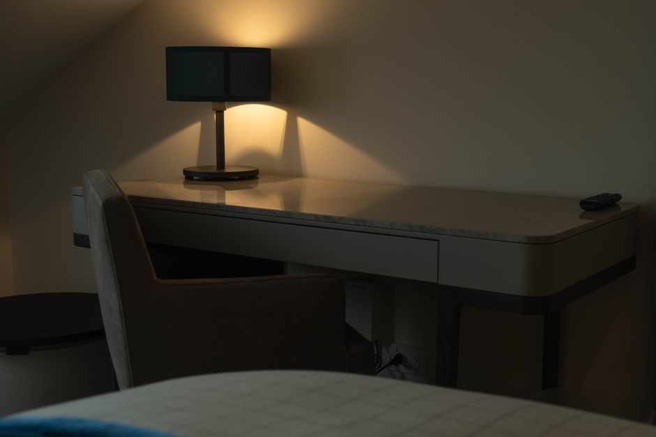 Small home office nook with a compact desk tucked into a bedroom corner