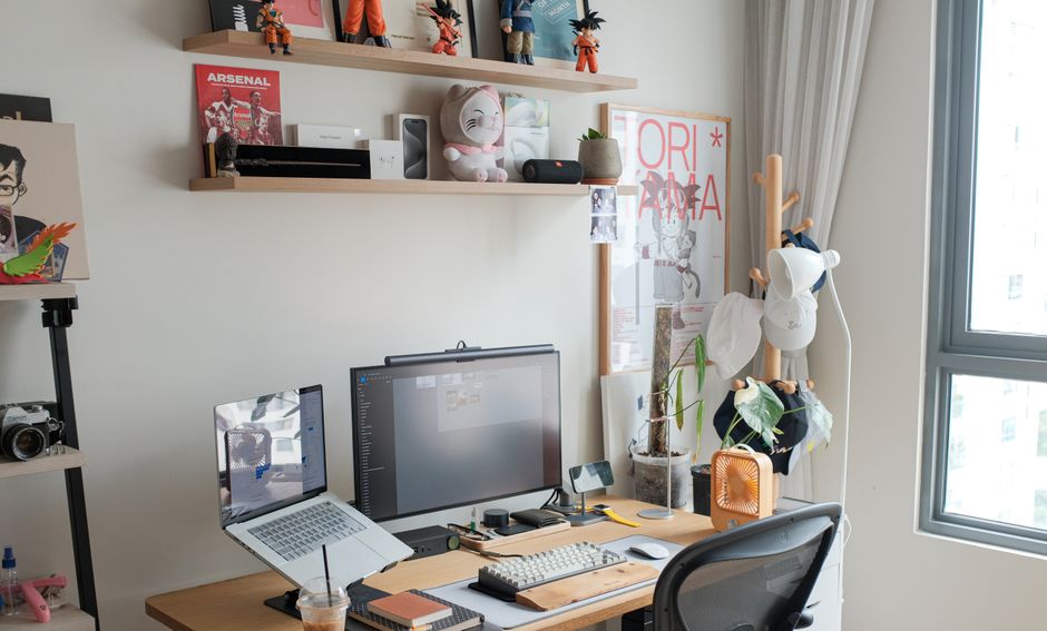 Floating shelves above a small desk holding books and organized supplies