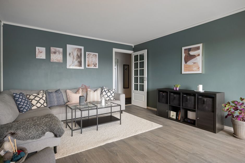 Contemporary living room featuring a cozy sectional sofa, coffee table, and decorative wall art.
