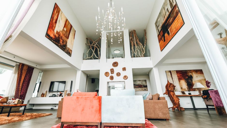 Living room with a deep emerald green accent wall behind a sofa