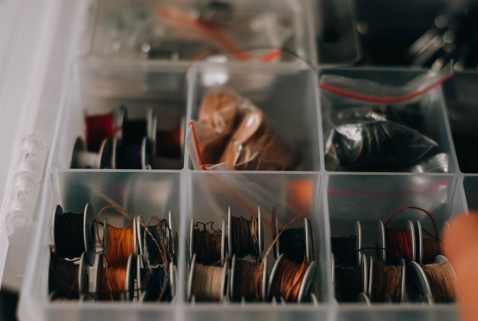 Organized craft room with labeled bins and pegboard storage