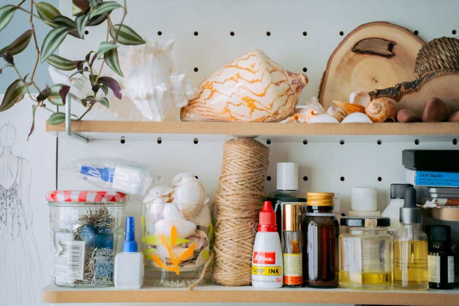 Pegboard wall organizer holding scissors, ribbon, and craft tools