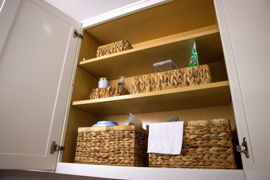 Bright laundry room with open shelving, labeled baskets, and folded towels