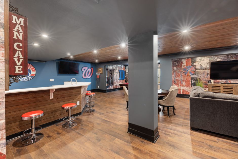 Gallery wall display of framed sports memorabilia and team decor