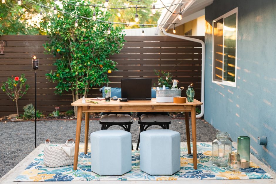 Small patio with cozy seating, string lights, and potted plants