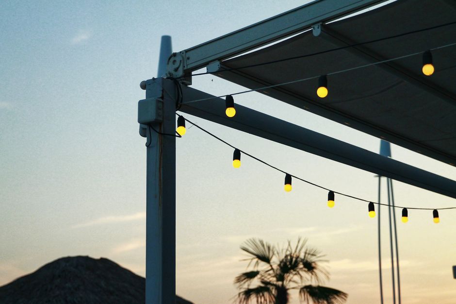 Small patio at dusk lit with warm string lights