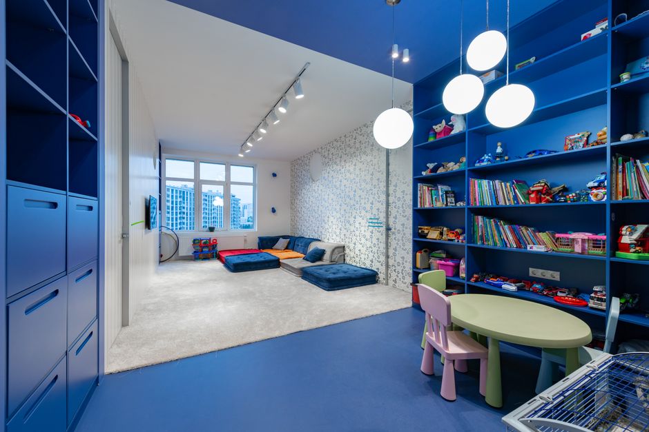 Wall-mounted shelves and bins in a compact playroom corner